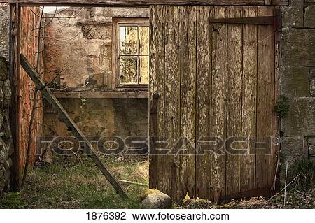 Stock Image - Northumberland, England; An Abandoned Building In Ruins With A Broken Wooden Door. Fotosearch