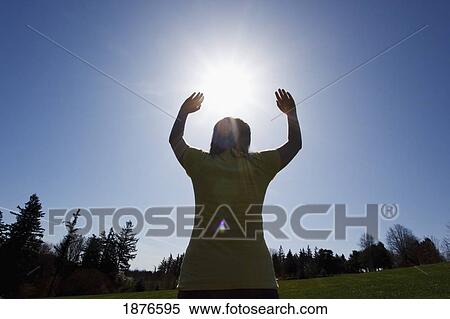Stock Photography - Oregon, United States Of America; A Teenage Girl With Her Arms Raised. Fotosearch