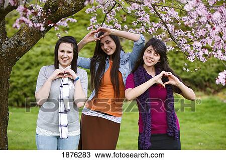 Portland, Oregon, United States Of America; Three Teenage Girls Making Heart Shapes With Their Hands In Portland Park View Large Photo Image Stock Image - Portland, Oregon, United States Of America; Three Teenage Girls Making Heart Shapes With Their Hands In Portland Park. Fotosearch