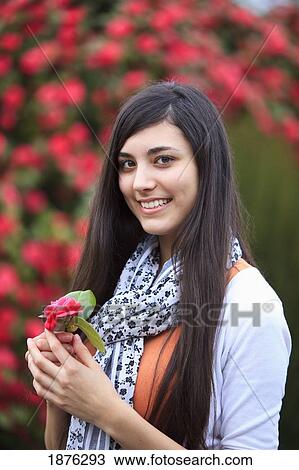 Portland, Oregon, United States Of America; A Teenage Girl Holding A Flower By A Tree Full Of Blossoms In Portland Park View Large Photo Image Stock Image - Portland, Oregon, United States Of America; A Teenage Girl Holding A Flower By A Tree Full Of Blossoms In Portland Park. Fotosearch
