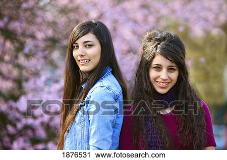Stock Image - Portland, Oregon, United States Of America; Two Teenage Girls Standing In Portland Park. Fotosearch