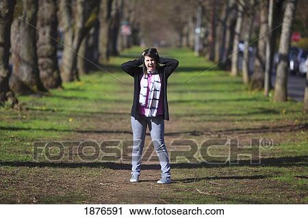 Stock Image - Portland, Oregon, United States Of America; A Teenage Girl Posing In A Park. Fotosearch