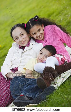 Portland, Oregon, United States Of America; A Boy And Two Girls Sitting On A Blanket On The Grass In Westmorland Park View Large Photo Image Stock Image - Portland, Oregon, United States Of America; A Boy And Two Girls Sitting On A Blanket On The Grass In Westmorland Park. Fotosearch
