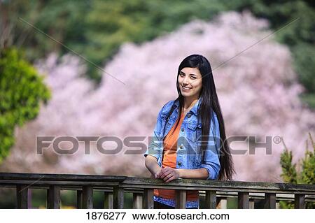 Portland, Oregon, United States Of America; A Teenage Girl Standing Against A Railing In Portland Park View Large Photo Image Stock Photo - Portland, Oregon, United States Of America; A Teenage Girl Standing Against A Railing In Portland Park. Fotosearch