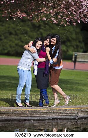 Portland, Oregon, United States Of America; Three Teenage Girl Standing In An Embrace In Portland Park View Large Photo Image Stock Photo - Portland, Oregon, United States Of America; Three Teenage Girl Standing In An Embrace In Portland Park. Fotosearch