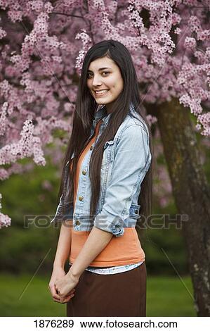 Portland, Oregon, United States Of America; A Teenage Girl By A Tree Full Of Blossoms In Portland Park View Large Photo Image Stock Photo - Portland, Oregon, United States Of America; A Teenage Girl By A Tree Full Of Blossoms In Portland Park. Fotosearch