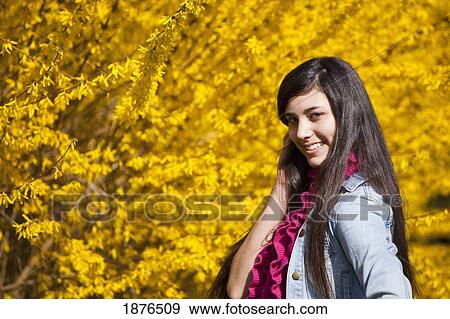 Stock Photo - Portland, Oregon, United States Of America; A Teenage Girl Poses In Front Of A Tree With Autumn Colors In Portland Park. Fotosearch