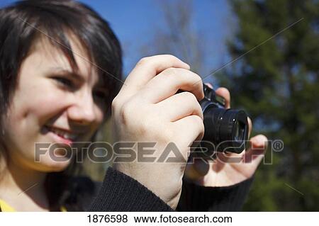 Portland, Oregon, United States Of America; A Teenage Girl Takes A Picture With Her Camera In A Park View Large Photo Image Stock Photo - Portland, Oregon, United States Of America; A Teenage Girl Takes A Picture With Her Camera In A Park. Fotosearch