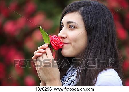 Portland, Oregon, United States Of America; A Teenage Girl Smelling A Flower In Portland Park View Large Photo Image Stock Photograph - Portland, Oregon, United States Of America; A Teenage Girl Smelling A Flower In Portland Park. Fotosearch