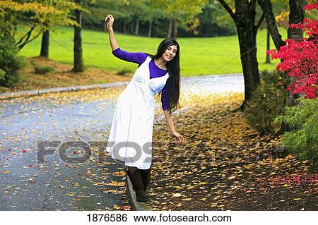 Portland, Oregon, United States Of America; A Teenage Girl Walks Balancing On A Curb In A Park View Large Photo Image Stock Photograph - Portland, Oregon, United States Of America; A Teenage Girl Walks Balancing On A Curb In A Park. Fotosearch