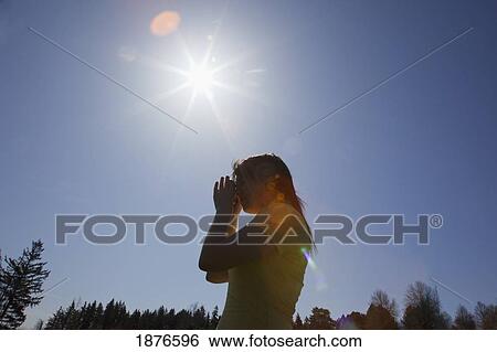 Stock Photograph - Portland, Oregon, United States Of America; A Teenage Girl Takes A Picture With Her Camera In A Park. Fotosearch