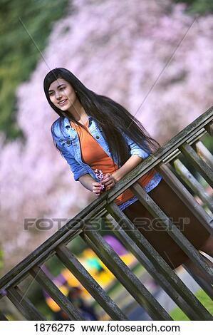 Portland, Oregon, United States Of America; A Teenage Girl Standing Against A Railing In Portland Park View Large Photo Image Stock Photography - Portland, Oregon, United States Of America; A Teenage Girl Standing Against A Railing In Portland Park. Fotosearch