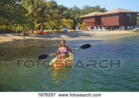 Stock Photo - Roatan, Bay Islands, Honduras; A Woman Kayaking At Anthony's Key Resort. Fotosearch