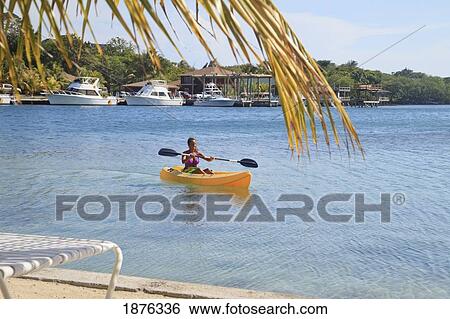 Stock Photograph - Roatan, Bay Islands, Honduras; A Woman Kayaking At Anthony's Key Resort. Fotosearch