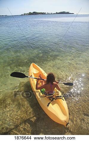 Roatan, Bay Islands, Honduras; A Young Woman Paddling A Kayak At Anthony's Key Resort View Large Photo Image Picture - Roatan, Bay Islands, Honduras; A Young Woman Paddling A Kayak At Anthony's Key Resort. Fotosearch