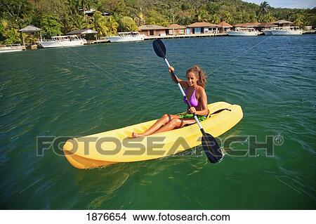 Roatan, Bay Islands, Honduras; A Young Woman Paddling A Kayak At Anthony's Key Resort View Large Photo Image Picture - Roatan, Bay Islands, Honduras; A Young Woman Paddling A Kayak At Anthony's Key Resort. Fotosearch