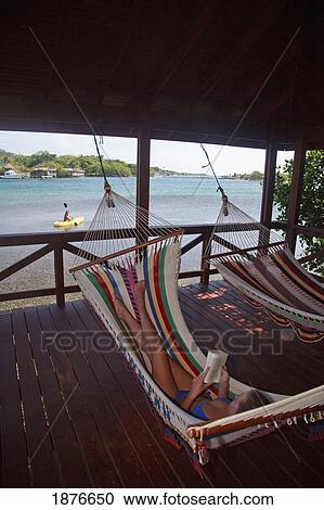 Roatan, Bay Islands, Honduras; A Young Woman Reading In A Hammock At Anthony's Key Resort View Large Photo Image Stock Image - Roatan, Bay Islands, Honduras; A Young Woman Reading In A Hammock At Anthony's Key Resort. Fotosearch