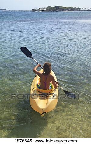 Stock Photography - Roatan, Bay Islands, Honduras; A Young Woman Paddling A Kayak At Anthony's Key Resort. Fotosearch