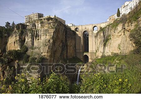 Stock Photo - Ronda, Andalusia, Spain; The Bridge With A Waterfall And Rock Cliffs. Fotosearch
