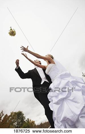 Stoney Creek, Ontario, Canada; A Bride And Groom Trying To Catch A Bouquet View Large Photo Image Stock Photography - Stoney Creek, Ontario, Canada; A Bride And Groom Trying To Catch A Bouquet. Fotosearch