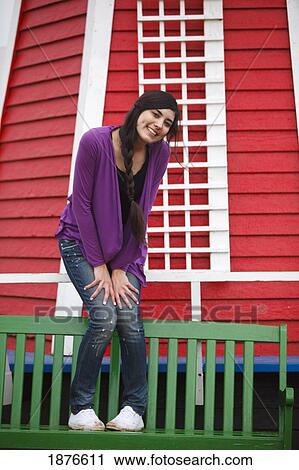 Woodburn, Oregon, United States Of America; A Teenage Girl Poses On A Green Bench In Front Of A Windmill At Wooden Shoe Tulip Farm View Large Photo Image Stock Image - Woodburn, Oregon, United States Of America; A Teenage Girl Poses On A Green Bench In Front Of A Windmill At Wooden Shoe Tulip Farm. Fotosearch