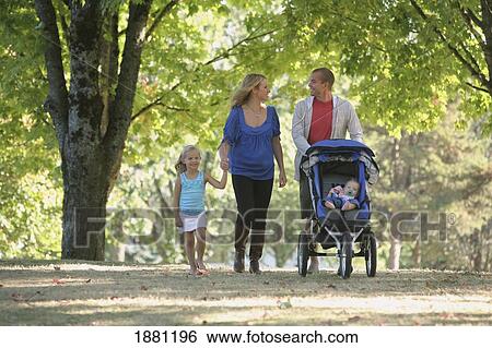 Stock Photograph - a family walking together in a park; gresham, oregon, united states of america. Fotosearch