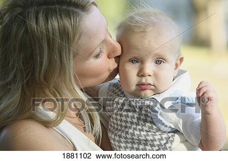 a mother kissing her baby boy; gresham, oregon, united states of america View Large Photo Image Stock Image - a mother kissing her baby boy; gresham, oregon, united states of america. Fotosearch