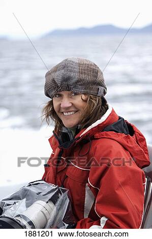a woman holding a camera wrapped in plastic on a cruise ship tour; juneau, alaska, united states of america View Large Photo Image Stock Image - a woman holding a camera wrapped in plastic on a cruise ship tour; juneau, alaska, united states of america. Fotosearch