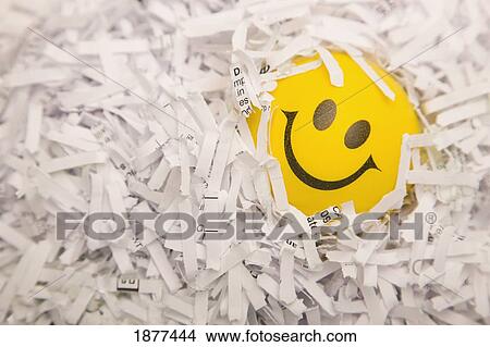 a yellow happy face in paper shreds; edmonton, alberta, canada View Large Photo Image Picture - a yellow happy face in paper shreds; edmonton, alberta, canada. Fotosearch