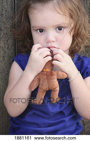 Stock Image - a young girl with a teddy bear; gresham, oregon, united states of america. Fotosearch