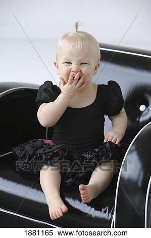 a young girl yawning in a chair; gresham, oregon, united states of america View Large Photo Image Stock Photography - a young girl yawning in a chair; gresham, oregon, united states of america. Fotosearch
