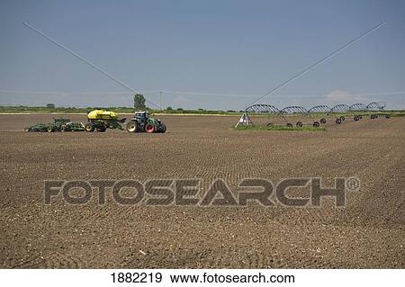 Stock Photo - air seeder planting in a tilled field; alberta, canada. Fotosearch