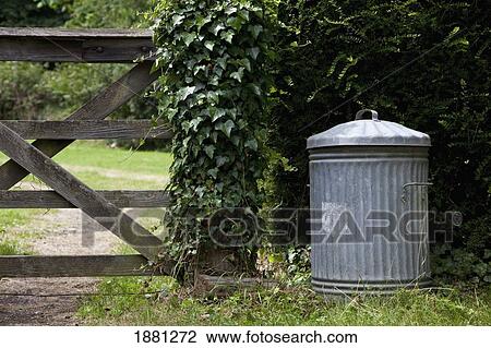 Stock Image - an old metal trash can; northumberland, england. Fotosearch