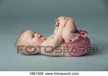 baby girl exploring feet View Large Photo Image Stock Photo - baby girl exploring feet. Fotosearch