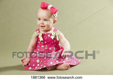 baby girl sitting with a bow in her hair View Large Photo Image Stock Photograph - baby girl sitting with a bow in her hair. Fotosearch