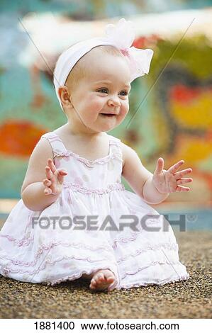 Stock Image - baby girl smiling and waving; nashville, tennessee, united states of america. Fotosearch