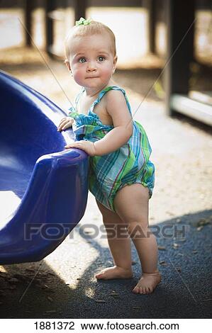 baby girl standing at a slide View Large Photo Image Stock Image - baby girl standing at a slide. Fotosearch