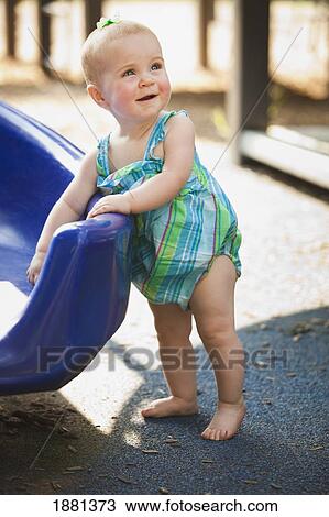 baby girl standing at a slide View Large Photo Image Stock Image - baby girl standing at a slide. Fotosearch