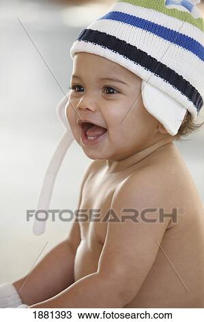 Stock Image - baby wearing a striped hat. Fotosearch