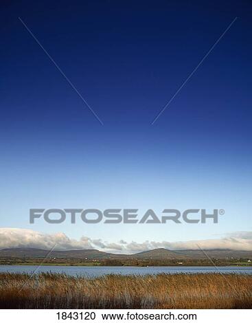 Stock Image - Bawnboy, Brackle Lough, Co Covan, Ireland; Brackley Lough With Cuilcagh Mountains In The Background. Fotosearch