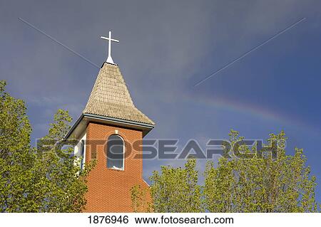 calgary, alberta, canada; a church steeple and cross framed by trees and a blue sky View Large Photo Image Stock Photograph - calgary, alberta, canada; a church steeple and cross framed by trees and a blue sky. Fotosearch