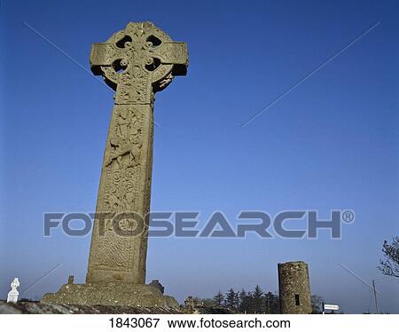 Celtic Cross In A Burial Ground With A Round Tower In The Background View Large Photo Image Stock Photo - Celtic Cross In A Burial Ground With A Round Tower In The Background. Fotosearch