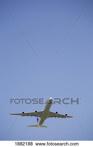 commercial airplane in flight; calgary, alberta, canada View Large Photo Image Stock Photo - commercial airplane in flight; calgary, alberta, canada. Fotosearch
