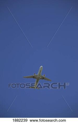 commercial airplane in flight; calgary, alberta, canada View Large Photo Image Stock Photo - commercial airplane in flight; calgary, alberta, canada. Fotosearch