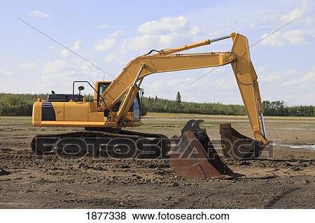 Stock Photo - edmonton, alberta, canada; a back hoe at a construction site. Fotosearch
