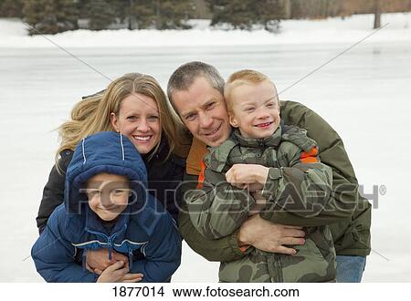 Picture - edmonton, alberta, canada; a family outdoors and dressed for winter weather. Fotosearch