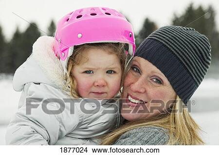 Picture - edmonton, alberta, canada; a mother and daughter on an outdoor ice rink. Fotosearch