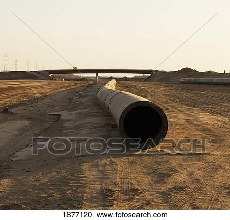Stock Image - edmonton, alberta, canada; a pipe laying on the ground in a construction site. Fotosearch
