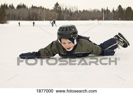 edmonton, alberta, canada; a young boy laying on his tummy on the ice while skating View Large Photo Image Stock Image - edmonton, alberta, canada; a young boy laying on his tummy on the ice while skating. Fotosearch