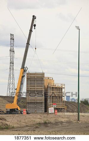 Stock Image - edmonton, alberta, canada; crane putting concrete form in place for bridge construction. Fotosearch